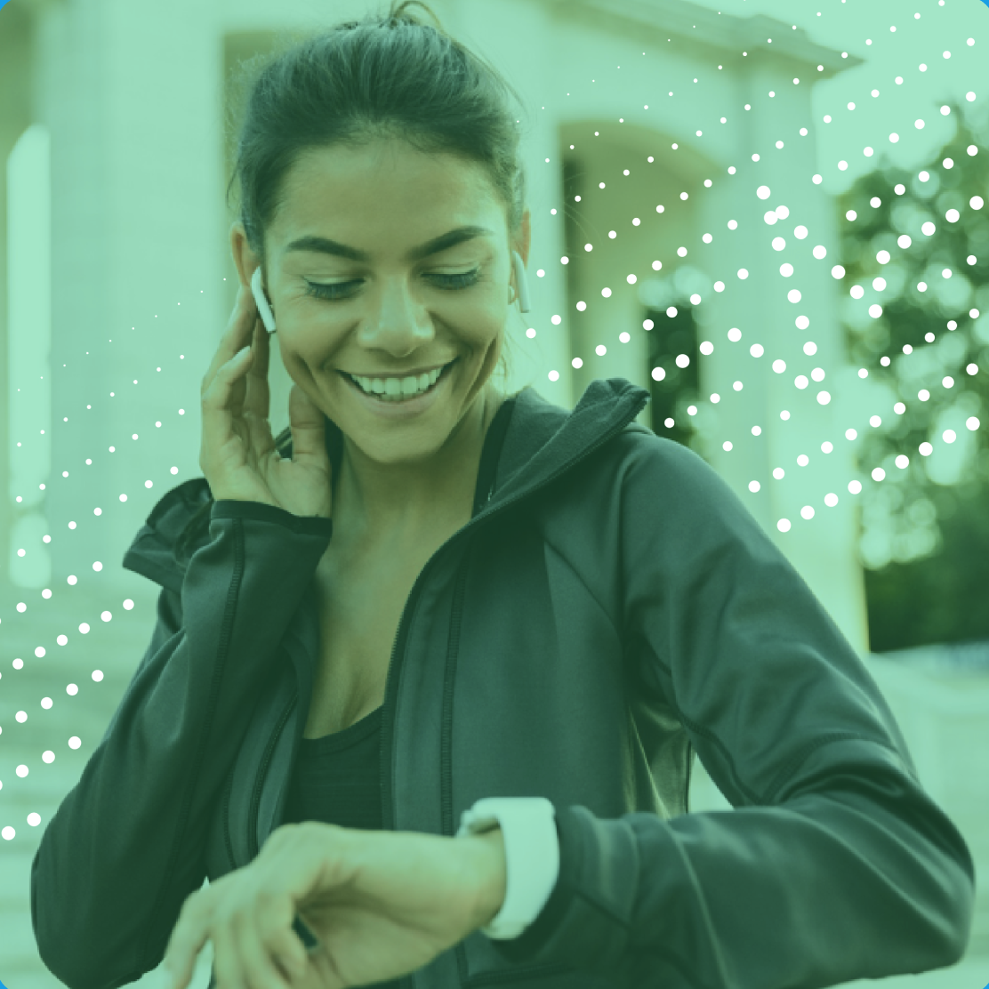Photo of a smiling woman doing sports while waring earbuds and a smart watch